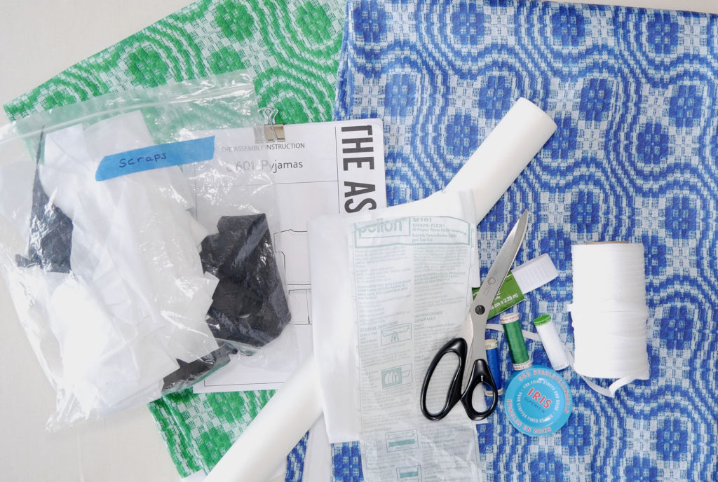 all the supplies you need; pattern, fabric, tape, tracing paper, interfacing, scissors, thread, elastic