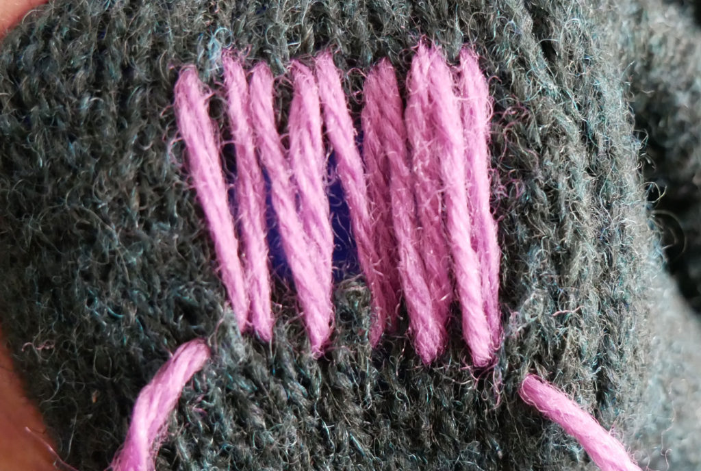 Vertical rows of yarn are stitched first