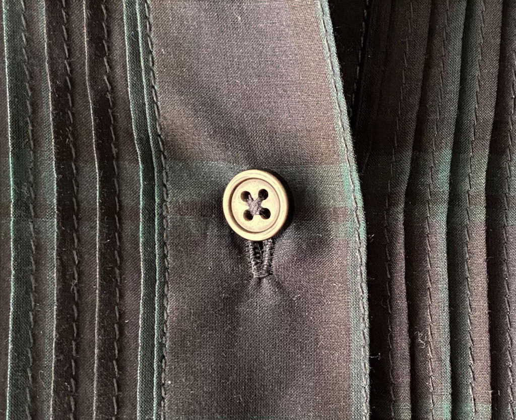 button sewn onto a shirt