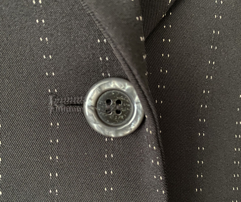 button sewn onto a jacket