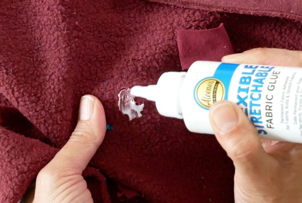 applying Aleene's Flexible Stretchable glue to sweatshirt