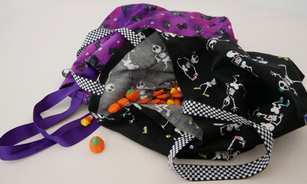 the purple cat bag and the black skeleton bag