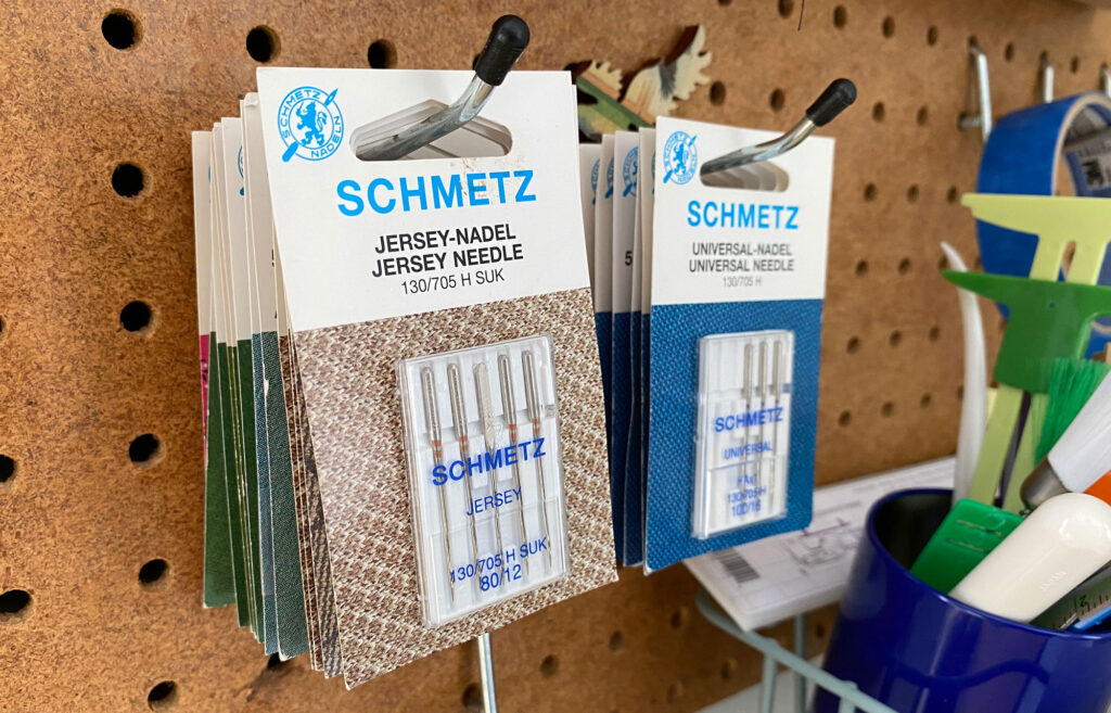 needle packs hanging on a peg board